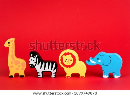 Toy animals isolated against a red background