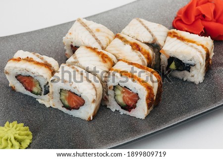 Assorted Rolls and sushi on a gray plate on a white background.Photos for restaurants and cafes.