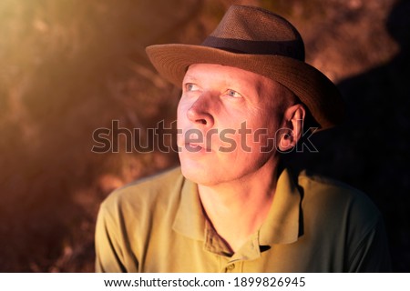 Mature man looking at magic sunshine. Concept of insight, solution or god.