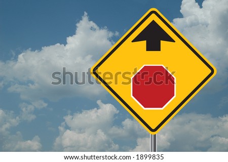 Stop ahead sign with clouds in the background