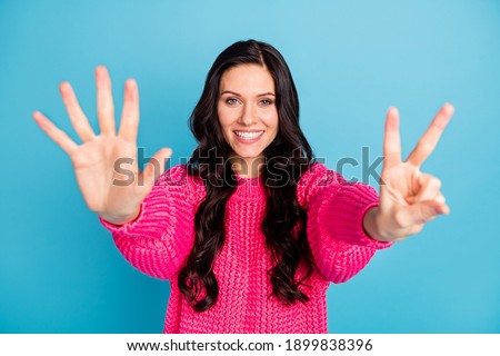 Photo of adorable person toothy smile show arms fingers numbers counting isolated on blue color background