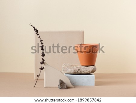 Minimalist still life composition with flower pot and natural nature materials: stone, marble, earthy clay in beige color, copy space, abstract modern art design concept Royalty-Free Stock Photo #1899857842
