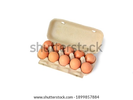 Chicken brown eggs in carton box isolated on white background with clipping path