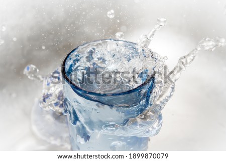 A splash of water in a glass, splashes and drops of water