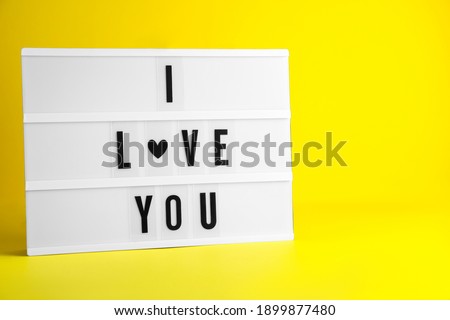 Decorative lightbox with phrase I love You on yellow background. Space for text