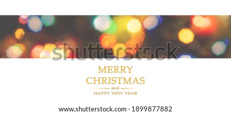 Merry Christmas and Happy New Year greeting card, blurred background of the twinkling lights of the Christmas tree. Greeting card background.