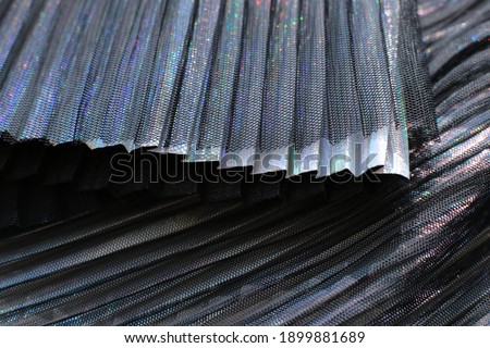 Fashionable pleated fabric close-up background, texture like accordion