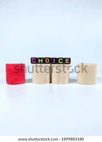 Selective focus.Word CHOICE from black dice on a block cylinder with white background.Shot were noise and film grain.