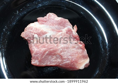 a piece of fresh pork steak