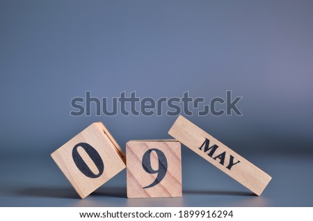 May 9, Cover in the evening time, Date Design with number cube for a background.