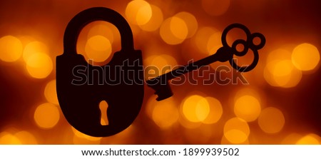silhouette of Vintage key and padlock isolated on blur bokeh background. 