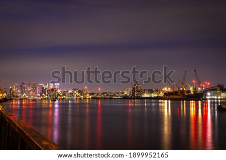 Long exposure view of Canary Wharf and Thames barrier in London, UK