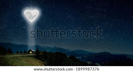The moon heart-shaped shines over the lovers' house on valentine's day 