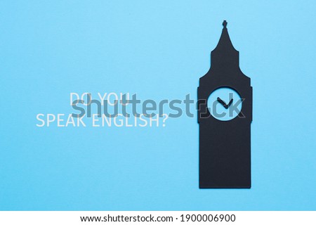 the big ben, cutout on a black paperboard, and the question do you speak english written on a blue background