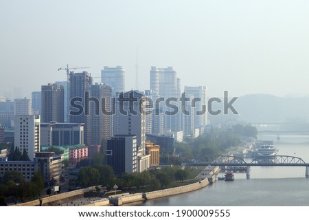 Skyline and Taedong River in the morning fog. View from the Yanggakdo island Royalty-Free Stock Photo #1900009555