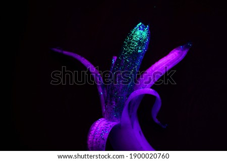   banana with sparkles on black background                             