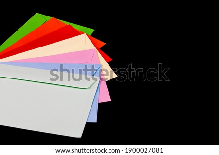 Colored envelopes on black background