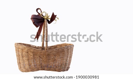 Brown wicker baskets on a white floor for storage.