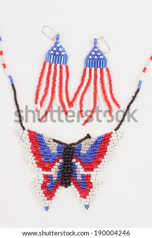 Fourth of July beaded jewelry of red, white and blue flag earrings and a butterfly necklace