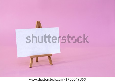 Wooden easel with white sheet. Vector illustration.