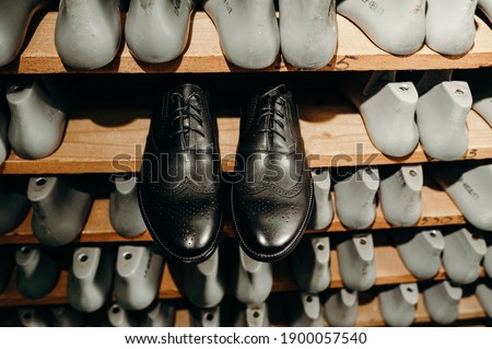 Black shoes. and blanks or pads for shoes are on the shelves in the cabinet in the shoe plant. Fashion