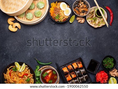Assorted of different Asian food. Chinese, Japanese and Thai cuisine. Noodles, dumplings gedza, baozi, sushi rolls, miso, ramen and tom yam Royalty-Free Stock Photo #1900062550
