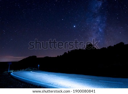 Long exposure night photography on a high mountain road of the milky way and the stars