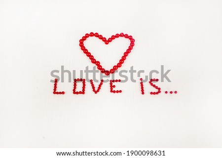 concept of Saint Valentine's Day holiday presented by heart made from red beads