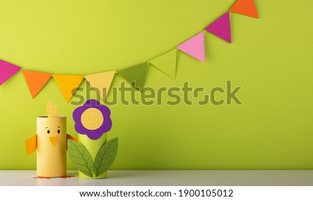 beautiful paper flower with cute handmade birds on green background. fresh spring and summer background