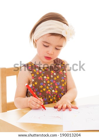 little girl with paints at the table.Isolated on white background.