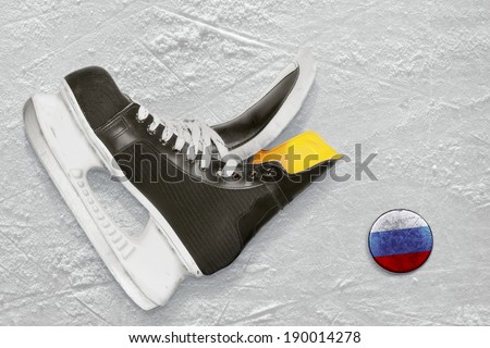 Hockey skates and the puck with the image of the Russian flag