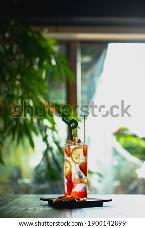 strawberry and citrus drink in green environment with plants inside coffeeshop