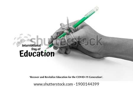 pen tightly knotted with hand. creative card idea for study, Perseverance, diligence, persistence, International Education Day, 24 January, Recover and revitalize education for the COVID 19 generation Royalty-Free Stock Photo #1900144399