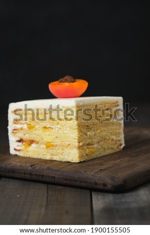 Fruit sponge cake in a cut. Cake with cream cheese cream and canned peach filling.
