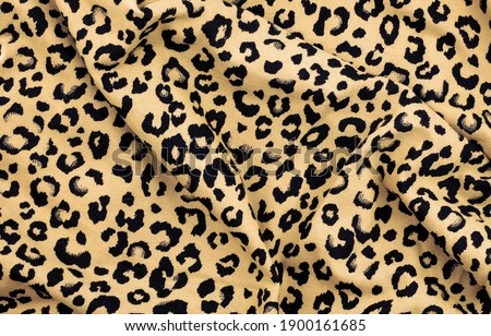 Abstract background with leopard texture, cotton fabric.