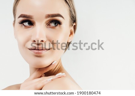 Close up photo of a woman with clean healthy skin looking to the side. Place for text.