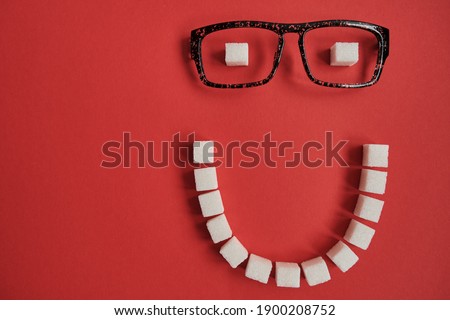 Smiling face made from sugar cubes