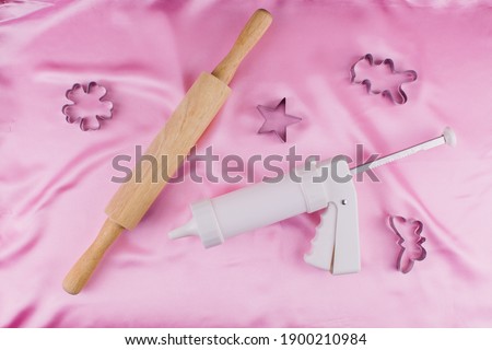 a pastry syringe with molds and rolling pin