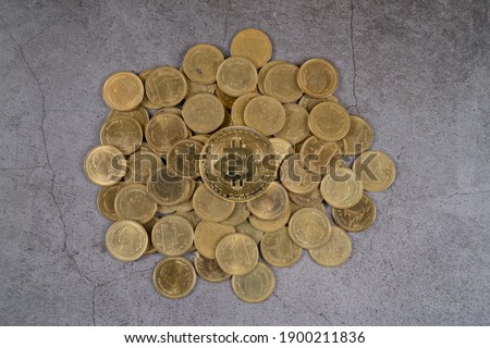 Top above overhead view photo of Golden bitcoins on pile of many coins.