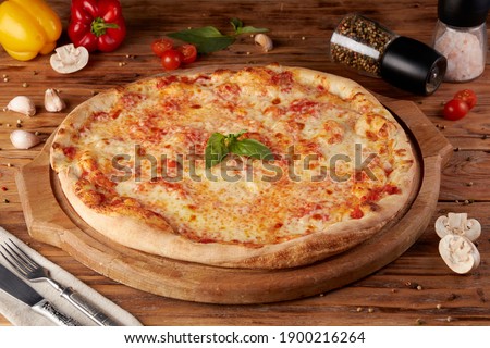 Pizza, variant of classic Italian pizza, wooden background