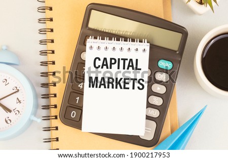 calculator with text CAPITAL MARKETS with white paper