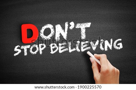 Don't Stop Believing text on blackboard, business concept background