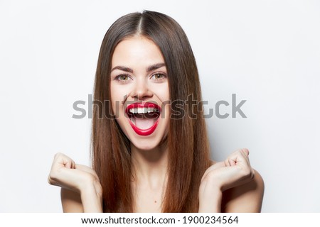 Woman portrait laughs clenched her hands into a fist attractive look 