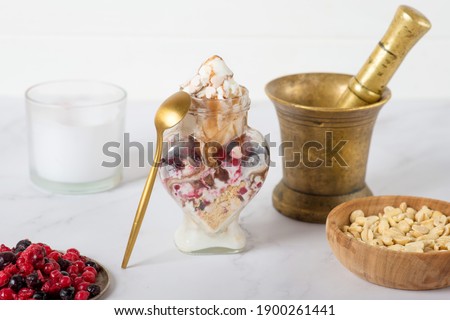 homemade berry ice cream in a jar. Delicious ice cream with fresh frozen berries and sauce, on color wooden background