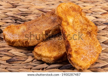 Fried bread with milk, egg, sugar and cinnamon (Torrijas). Typical Spanish Easter sweet. Horizontal photography and selective focus