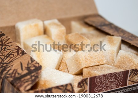Reed sugar in the form of cubes in a cardboard box