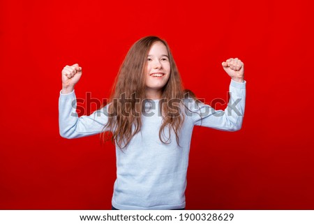Photo of cheerful child girl celebrating victory