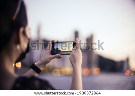 Girl taking photo with phone