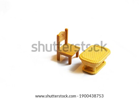 a brown table and chair stand on a white background