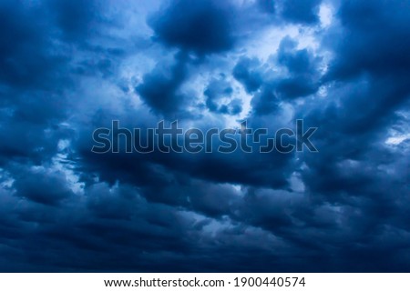 The big powerful storm clouds before a thunder-storm. Storm clouds at sunset.